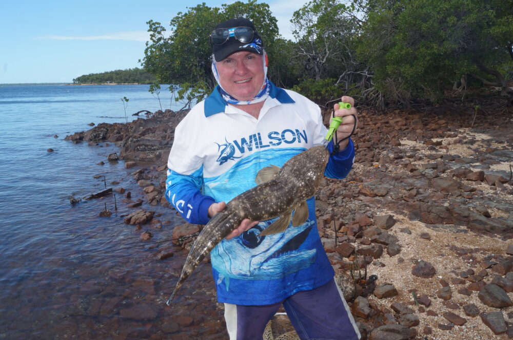 Gun Bundaberg angler Peter Myles with a flathead from the shallows behind him. It’s a decent fish given it was caught less than a rod length from the shore.