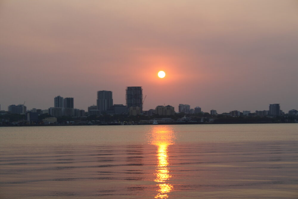 Sunset over the city of Darwin as seen from our canoe nearby on the flats.