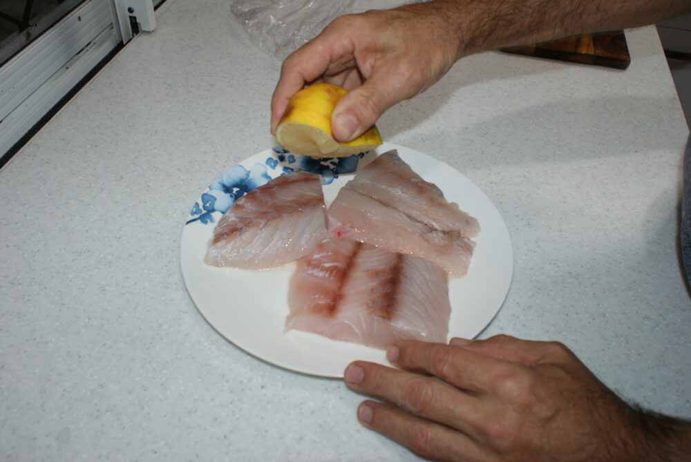 Generously squeeze lemon juice over the fillets.